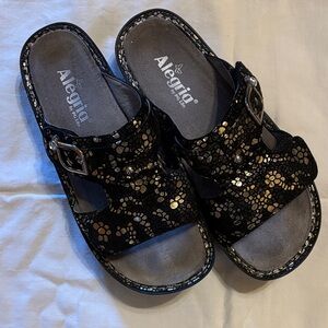 Alegria Black and Gold Patterned Sandals